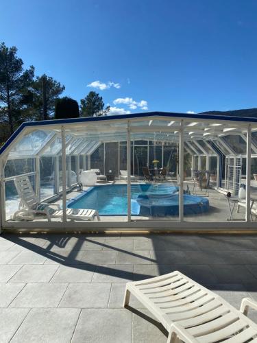 a pavilion with a swimming pool in a house at maisonette Cosi in Fayence
