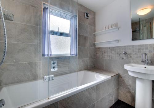 a bathroom with a tub and a sink at 12 New Street in Padstow