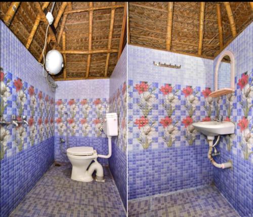 Auro Resort في أورفيلا: حمام من البلاط الأزرق مع مرحاض ومغسلة