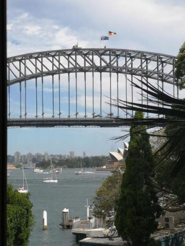 a bridge over the water with a view of the opera house at Harbourside7 - modern 1br unit with fab views in Sydney