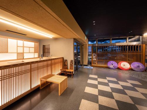 a room with a counter and a checkered floor at Mikuma Hotel in Hita