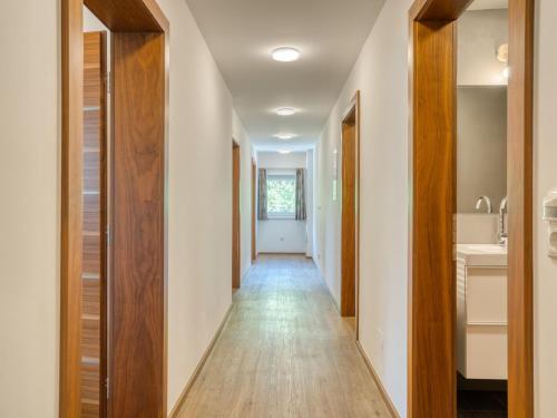 a hallway with white walls and wood floors at Apartment building Ferien, Neukirchen in Rosenthal