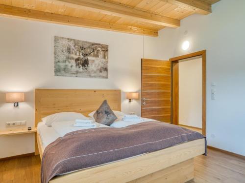 a bedroom with a large bed with a wooden headboard at Holiday Home in Neukirchen with Mountain Views in Rosenthal