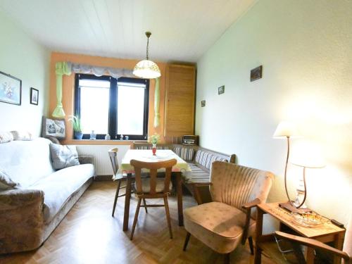 a living room with a couch and a table at Lovely Farmhouse in K hlungsborn near sea in Kühlungsborn