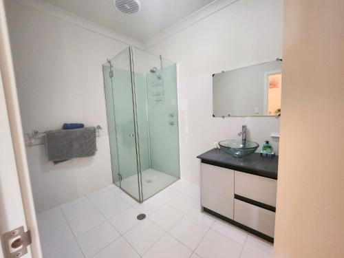 a bathroom with a glass shower and a sink at Unit 59 Seafront Estate in Jurien Bay