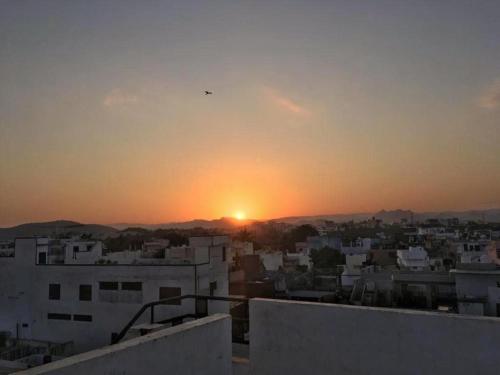 a sunset from the roof of a building at Panna Palace Guest House in Udaipur