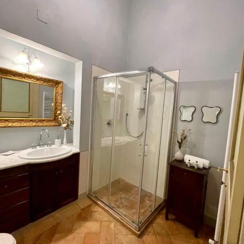 a bathroom with a glass shower and a sink at Palazzo Lauri Spoleto in Spoleto