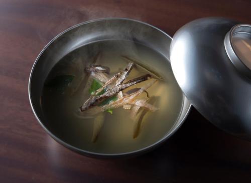 a metal bowl of soup with some food in it at ANA InterContinental Appi Kogen Resort by IHG in Hachimantai