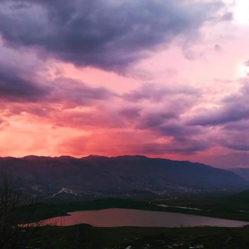 a view of a lake under a cloudy sky at Mateo & Sara Guesthouse. in Libohovë