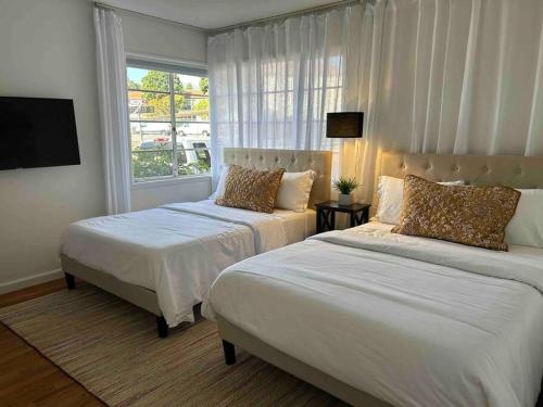 a bedroom with two beds and a window at Darling, Peaceful, Near Beach, EV Charger in Santa Barbara