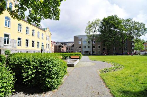 a walkway through a park next to buildings at Comfort Hotel Park in Trondheim