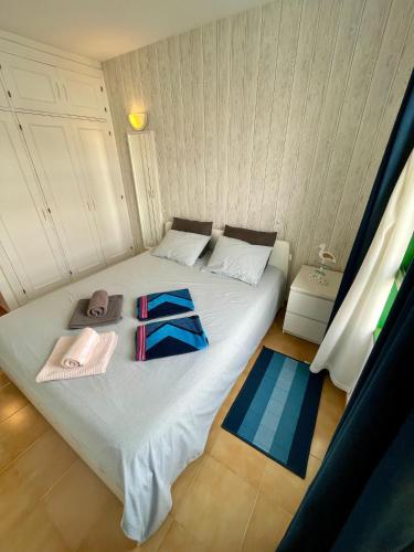 a bedroom with a bed with towels and hats on it at Casa Las Torres 209 in Costa de Antigua