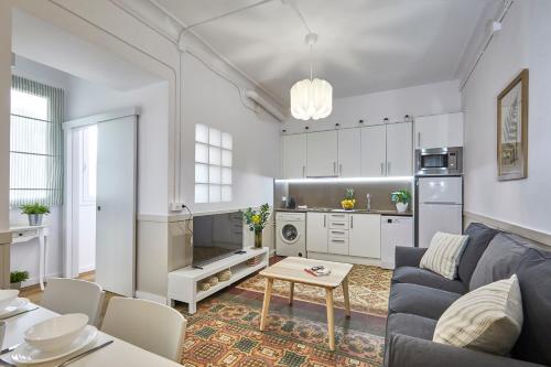 a living room with a couch and a table at BBarcelona Sagrada Familia Garden Apartment in Barcelona