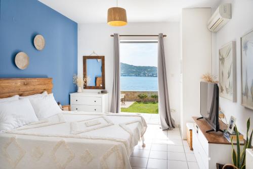 a bedroom with a bed and a view of the ocean at Villa peristeri in Alinda