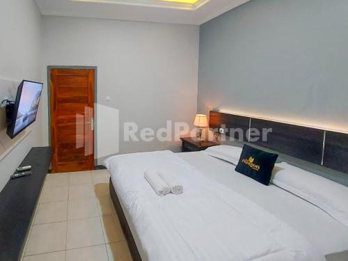 Postel nebo postele na pokoji v ubytování The Paragon Hotel Cilacap Redpartner