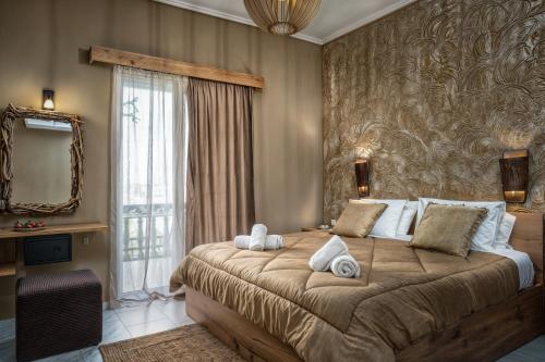 a bedroom with a large bed and a large window at Koklas Studios in Lithakia