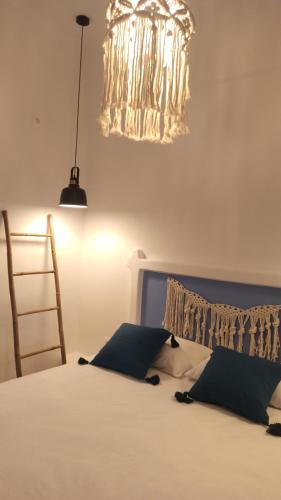a bedroom with a bed with a chandelier at Castle view in Panteli