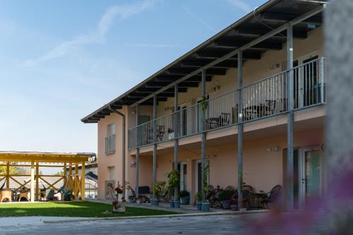 a building with tables and chairs on the balcony at Accommodation Baron in Ljubljana