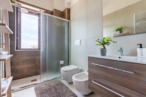 a bathroom with a shower and a toilet and a sink at Casa della Civetta in Monopoli