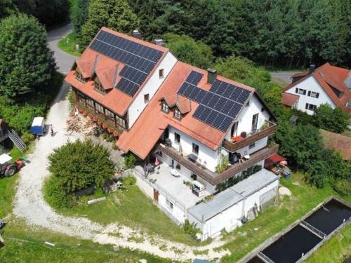 an aerial view of a house with solar panels on it at Alluring Apartment in Sch nsee in the forest in Schönsee