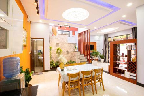 a dining room with a white table and chairs at Leila House - DaNang Central - 3BRs - Free Airport Shuttle in Da Nang