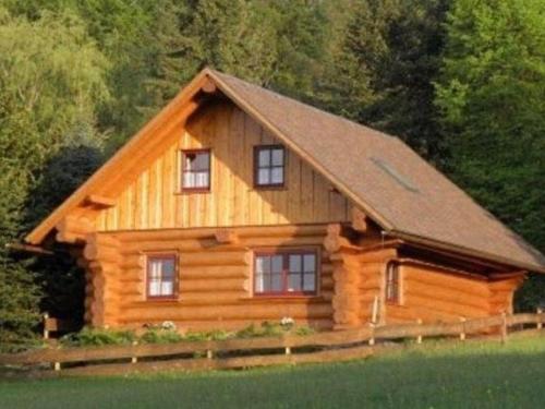 a large wooden cabin with a gambrel roof at Cozy wooden house in Waltershausen near the forest in Emsetal