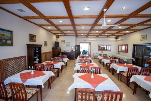 a dining room filled with tables and chairs at Komfort Hotel Platan in Harkány