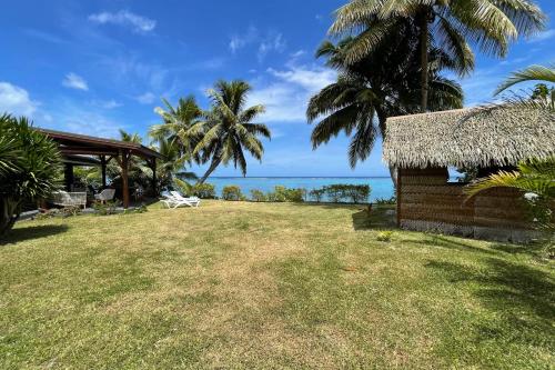 a house on the beach with the ocean in the background at Pae Miti Beach house - white sand beach - Tahiti - 7 people in Punaauia
