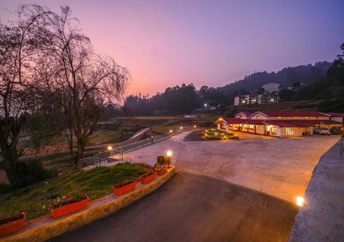a view of a parking lot at night at Lauriston Ooty Town Heritage Bungalow by VOYE HOMES in Ooty