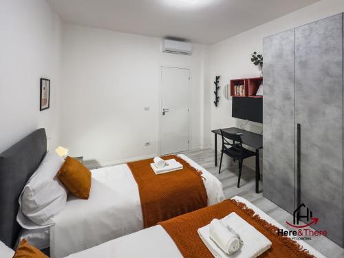 a bedroom with a bed and a desk in it at [Elegant Apartment] Airport 5min • A/C • Disney+ in Genoa