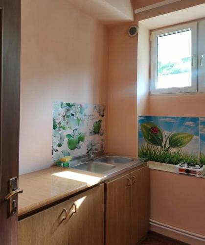 a kitchen with a sink and a window at MD Guest House in Getahovit