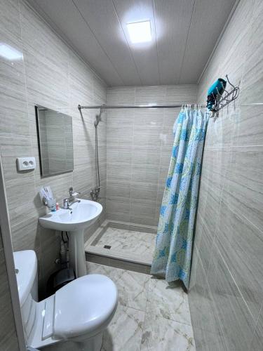 a bathroom with a toilet and a sink and a shower at Boutique Boulevard Bukhara in Bukhara
