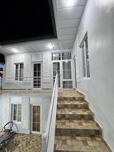 a staircase in a house with a tv on the wall at Boutique Boulevard Bukhara in Bukhara