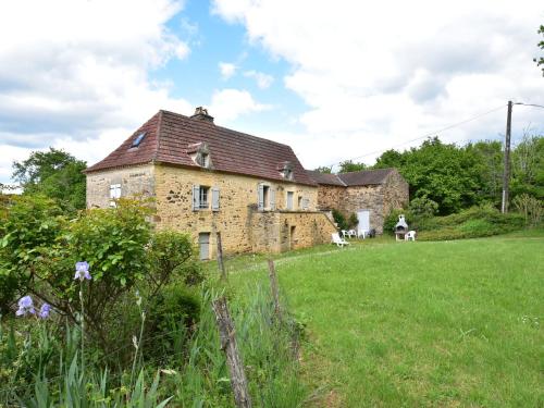an old stone house in a field of grass at Beautiful holiday home in wooded grounds near Villefranche du P rigord 7 km in Villefranche-du-Périgord