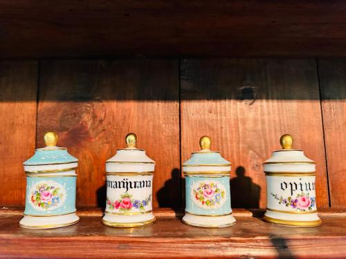 four vases sitting on top of a wooden table at ComeCasa La Magdeleine 2 Bedrooms Apartment in La Magdeleine
