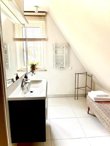 a bathroom with a sink and a staircase at Royal Attic Luxury Gdansk Old Town in Gdańsk