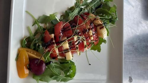 a white plate with a salad with fruits and vegetables at Millésime in Perville
