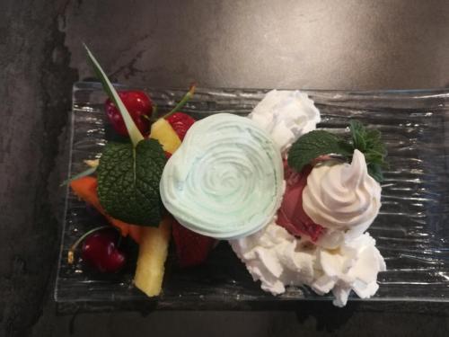 a plate of food with whipped cream and vegetables at Millésime in Perville