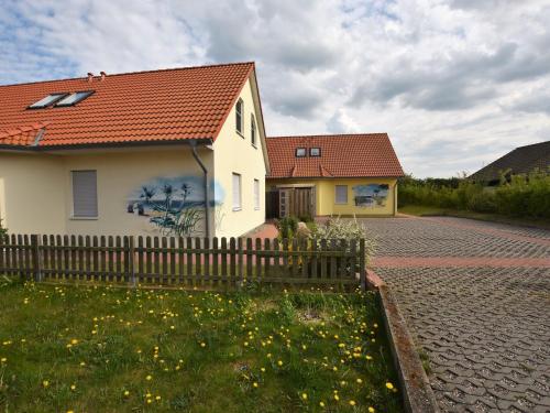 a house with a fence in front of it at Modern Holiday Home in Boiensdorf near Sea in Boiensdorf