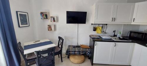 a kitchen with a sink and a counter with a table at Sun Beach 14 Espino Castillo in Caleta De Fuste