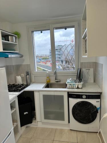 a kitchen with a sink and a dishwasher at Chambre proche de paris métro 7 La Courneuve 3 in La Courneuve
