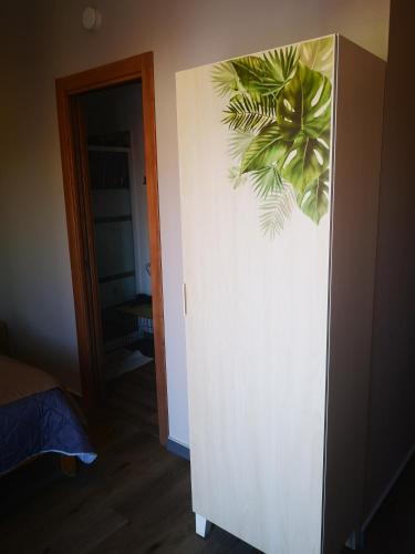 a room with a door with a plant on the wall at B&B Tonnarella Beach in Torre Forte