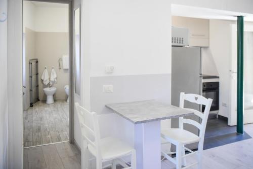 a kitchen with a table and chairs in a room at La Casa dei Laghi 2 Comabbio Monate Maggiore Orta in Mercallo