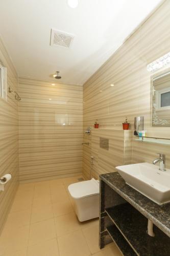 a bathroom with a sink and a toilet at Samiyog Tourist Resort in Pokhara