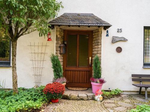 a front door of a house with a bench at Large detached holiday home in Willingen with garden in Willingen