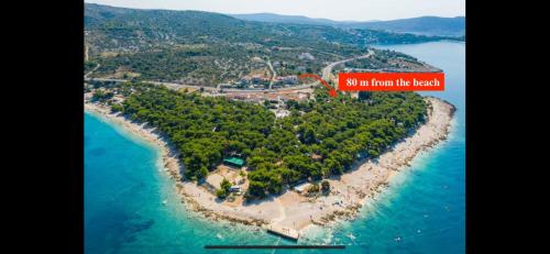an island in the ocean with a sign that says mi in front of the beach at Glamping Tents - Camp Adriatic in Primošten