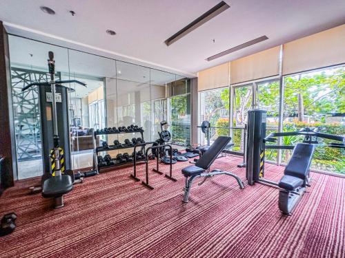 a gym with treadmills and elliptical machines at Exquisite 3BR Surabaya Apartment at Via Tower Ciputra World by Le Ciel Hospitality in Surabaya