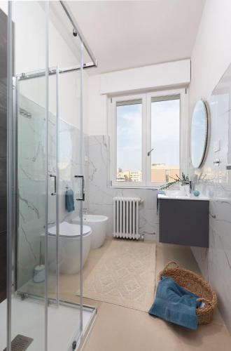 a bathroom with a shower and a toilet and a sink at Sve Suites Cagliari in Cagliari