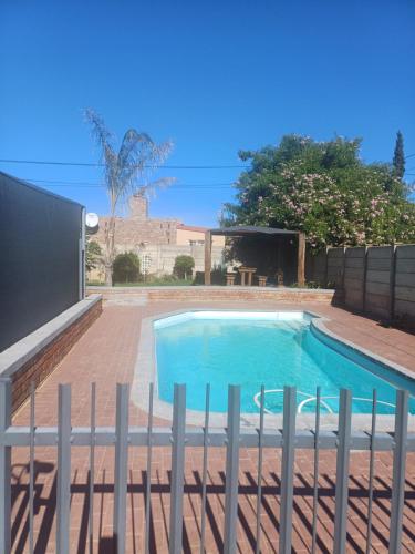 a swimming pool with a fence around it at Winemaker's Rest in Oudtshoorn