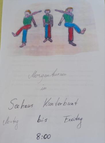 a drawing of three people dancing on a paper at Kunterbunt Seehaus in Faak am See